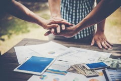 Business people making pile of hands. Teamwork concept.
